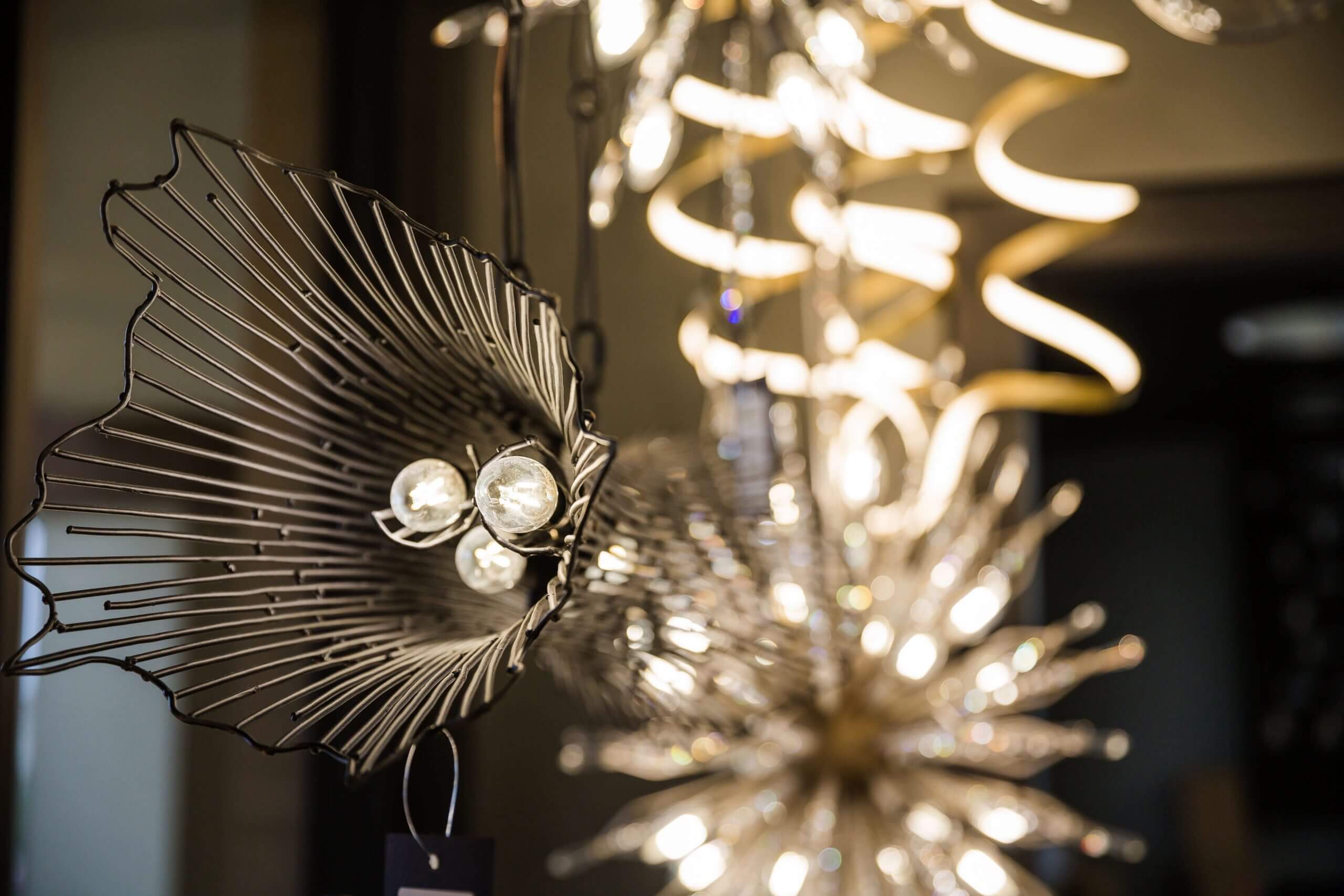 Chandeliers illuminated across the Xpress Lighting showroom ceiling