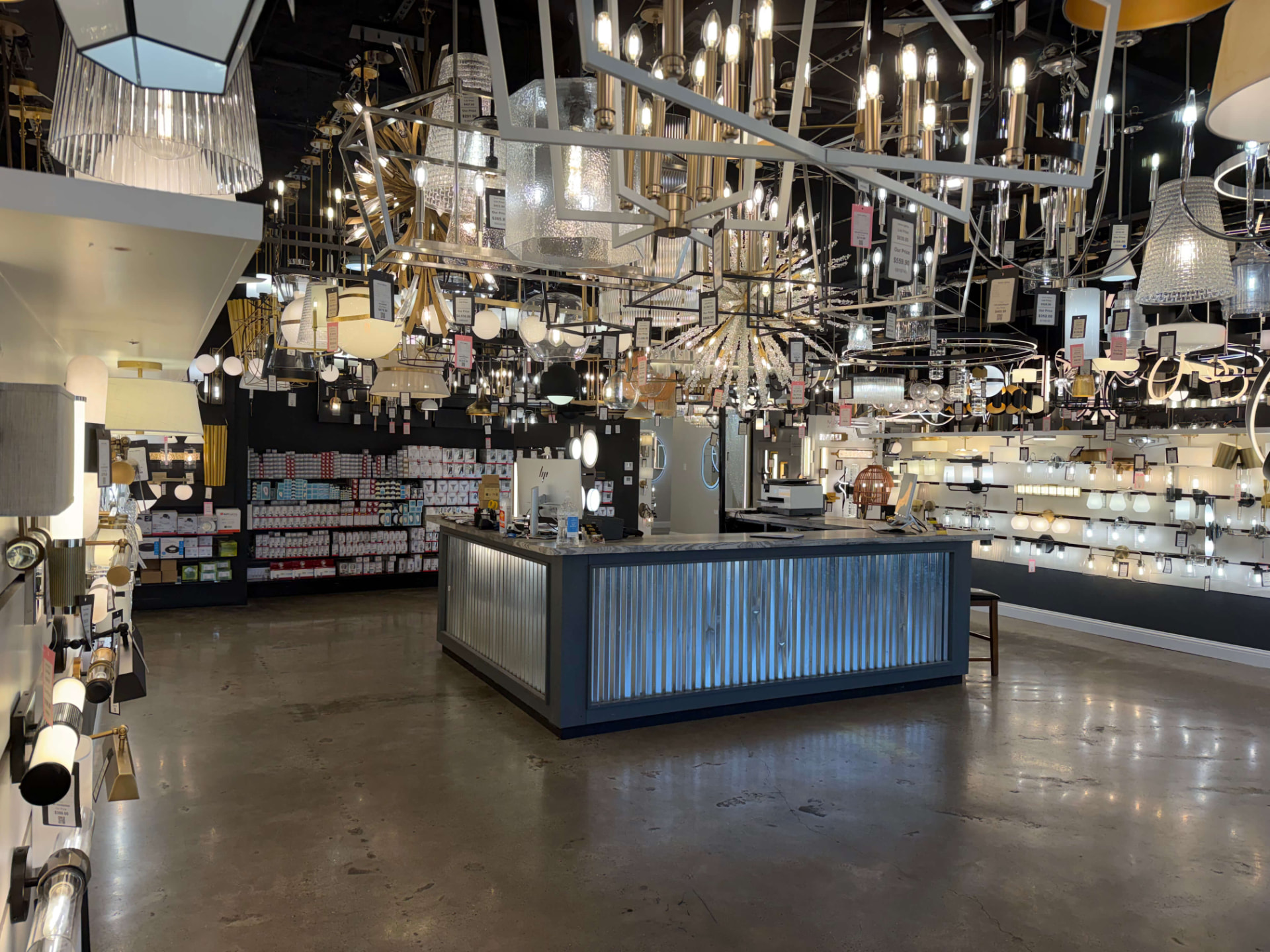 Interior of the Xpress Lighting showroom with illuminated displays and a central service counter